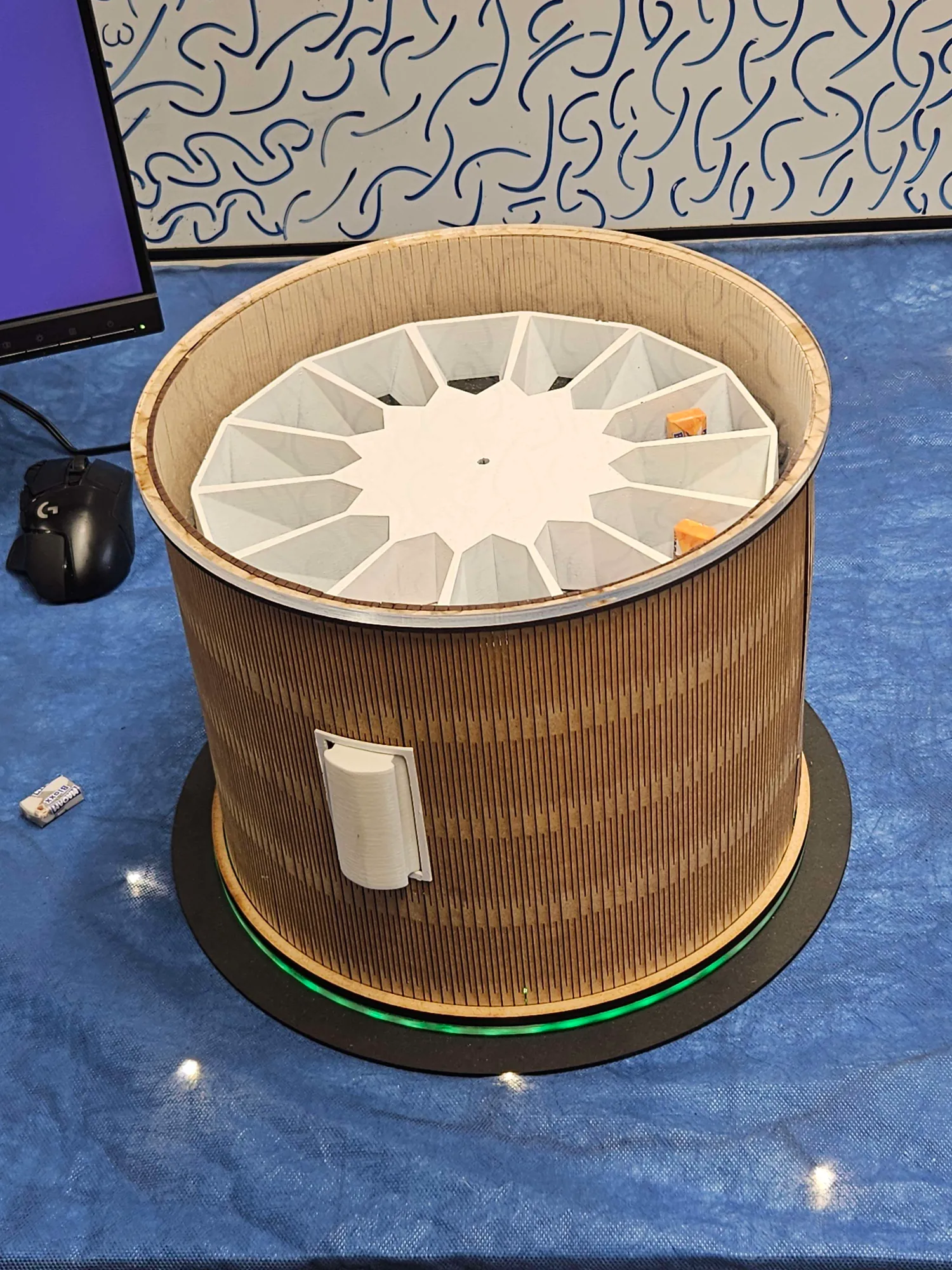 machine containing a windmill that moves small objects into a dispensable pocket